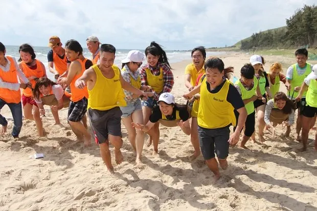 Team building at Hon Rom Beach with pristine space and camping, cultural exchange activities.