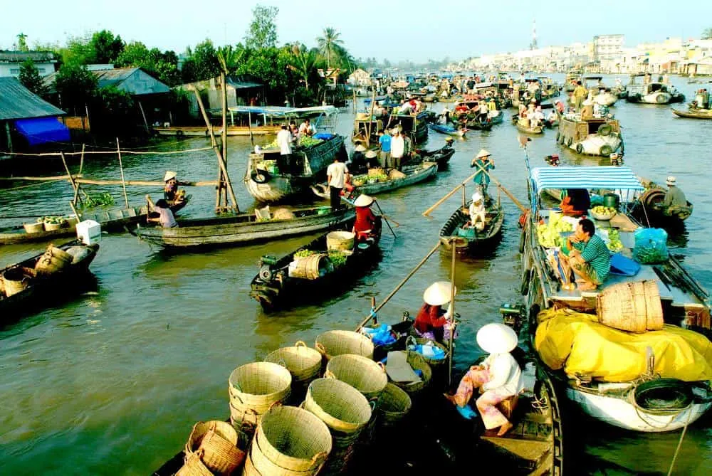 Enjoying street food on the river at Cai Be Floating Market