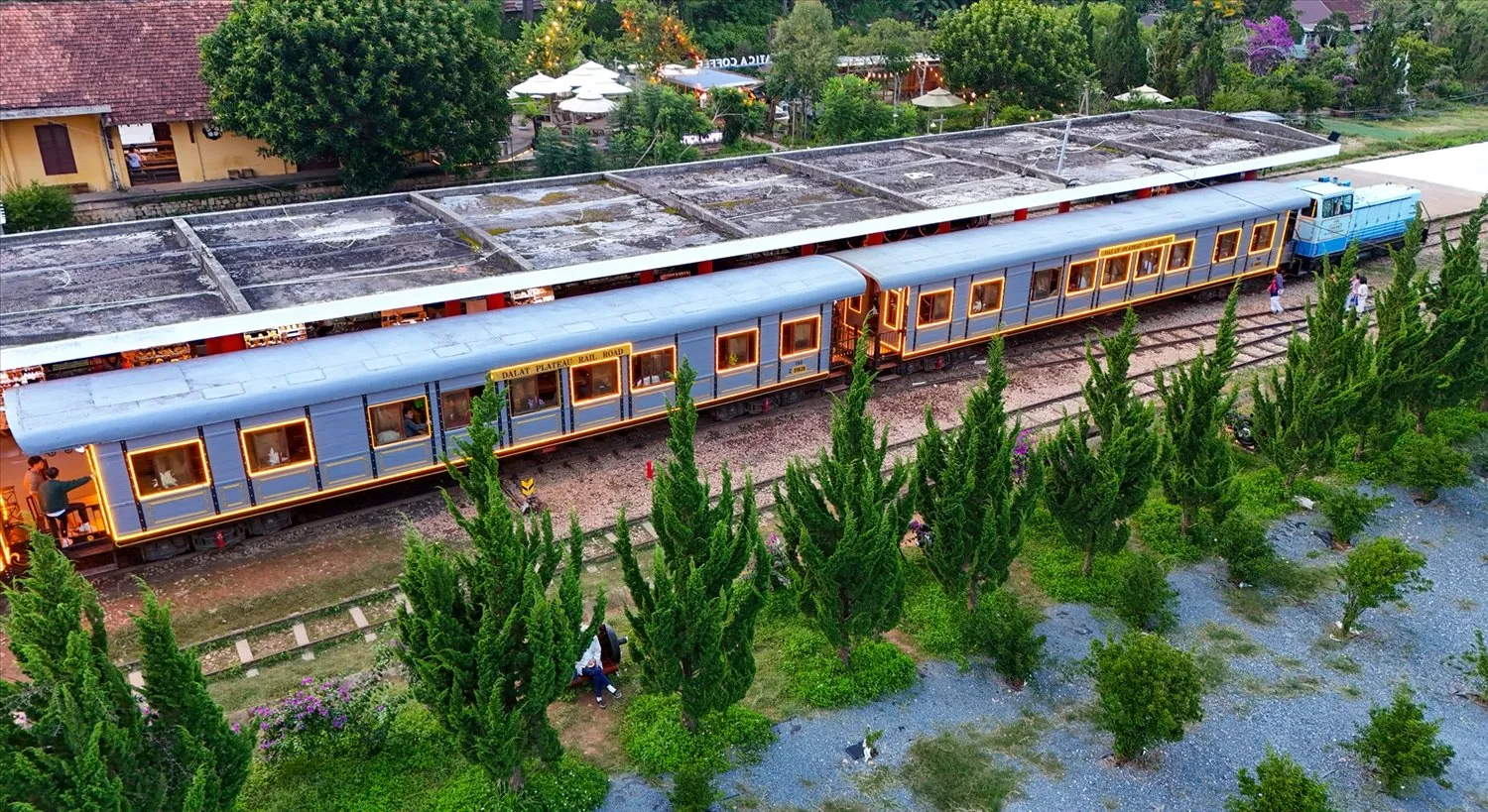 Vintage train carriage decorated with lights, creating a sparkling atmosphere for tourists