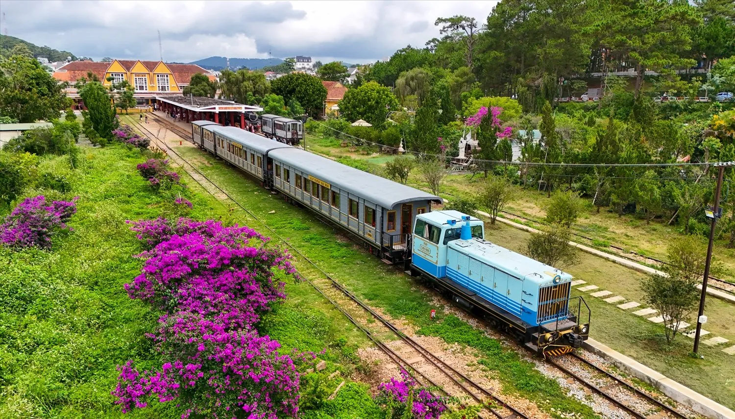Wooden carriages and diesel locomotive carrying passengers on the Da Lat - Trai Mat line