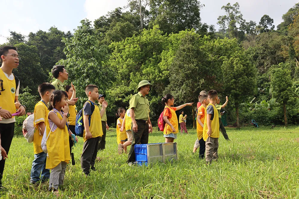 Tourists releasing a wild animal back to its natural habitat as part of the “Back Home” tour at Cuc Phuong National Park