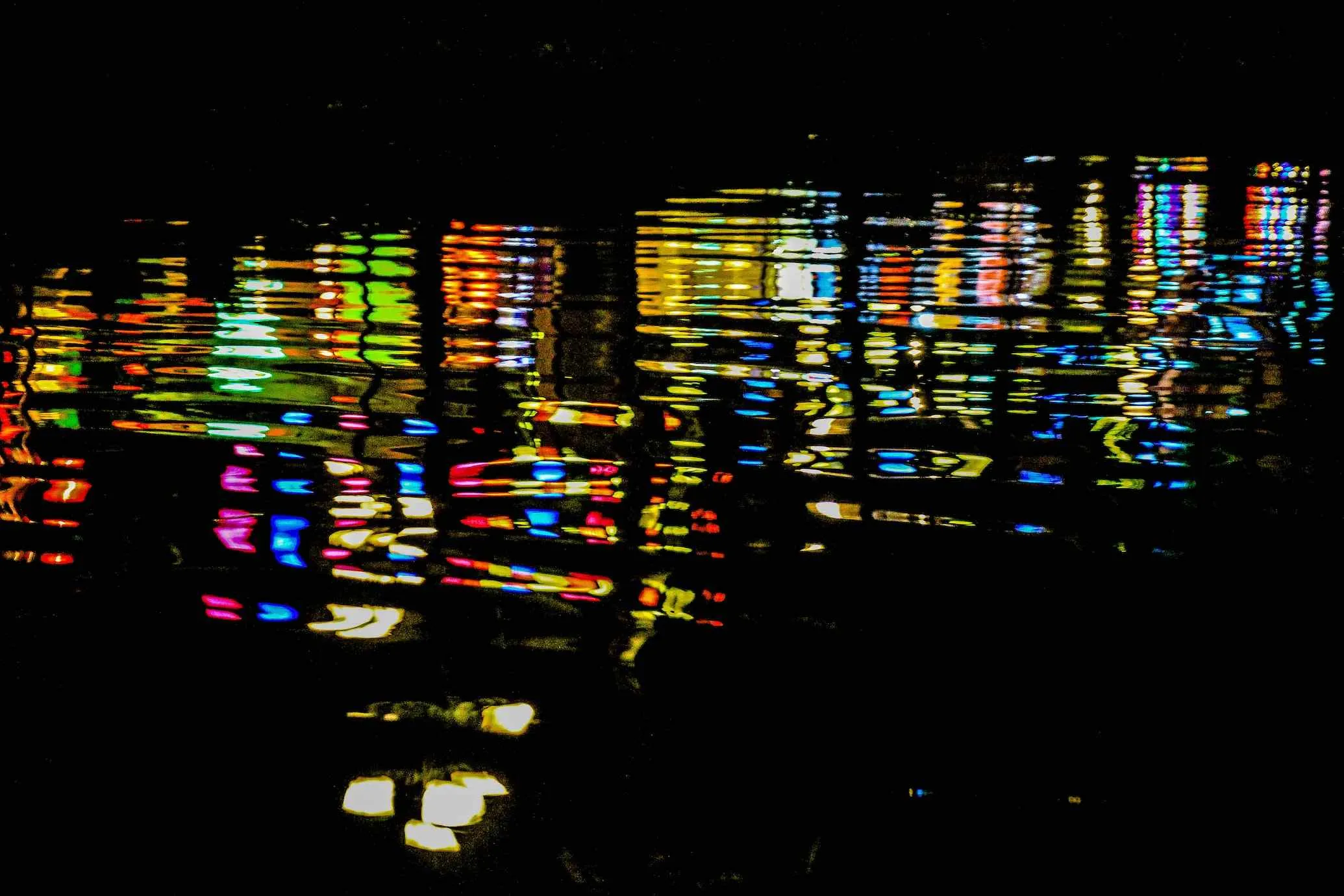Releasing lanterns on the Thu Bon River at night, creating a memorable and beautiful scene.